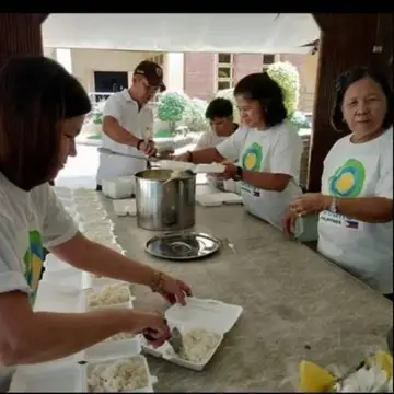 A group of Idealists work on a kitchen project together.