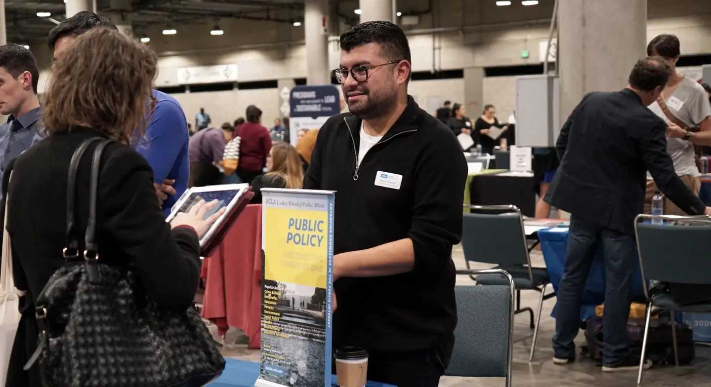 People talking at the Grad School Fair