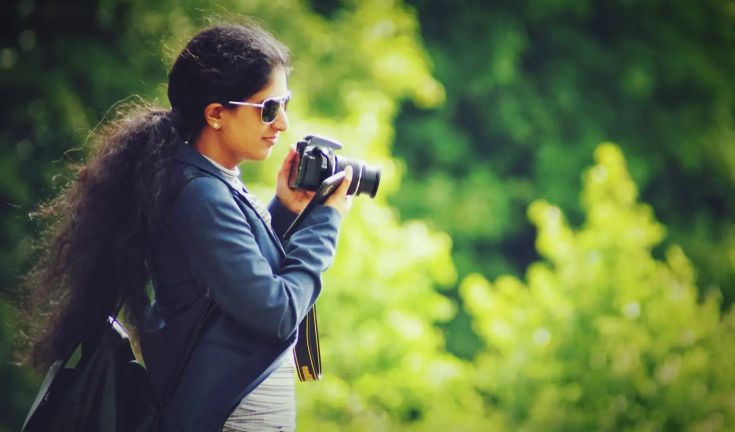 A photojournalist with a camera in hand, preparing to take a picture.