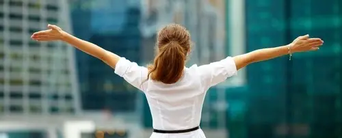 A woman with her arms raised triumphantly.